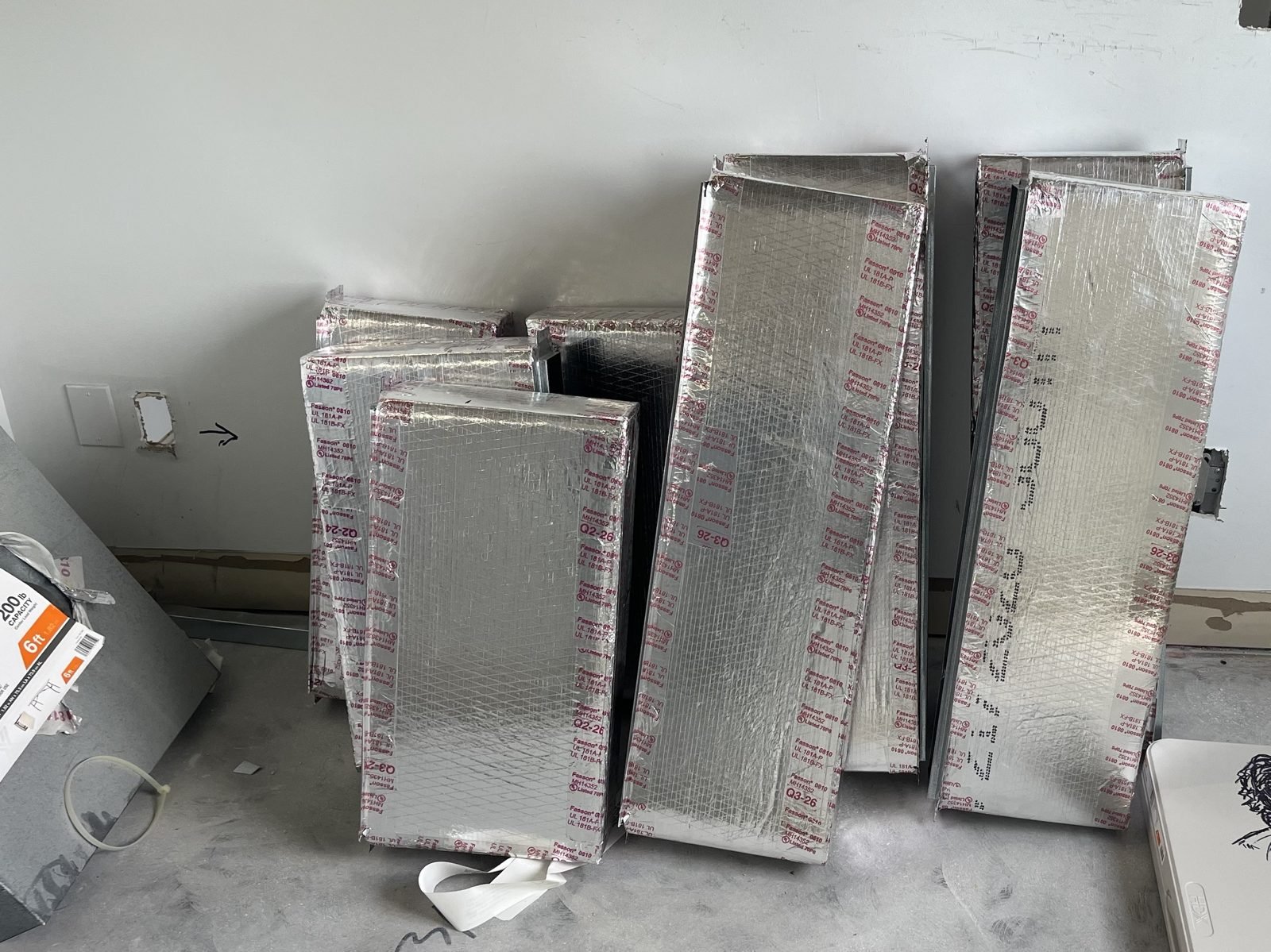 Linear cans, custom built, for mud in. We build them before the drywall so the slot disappears into the ceiling.