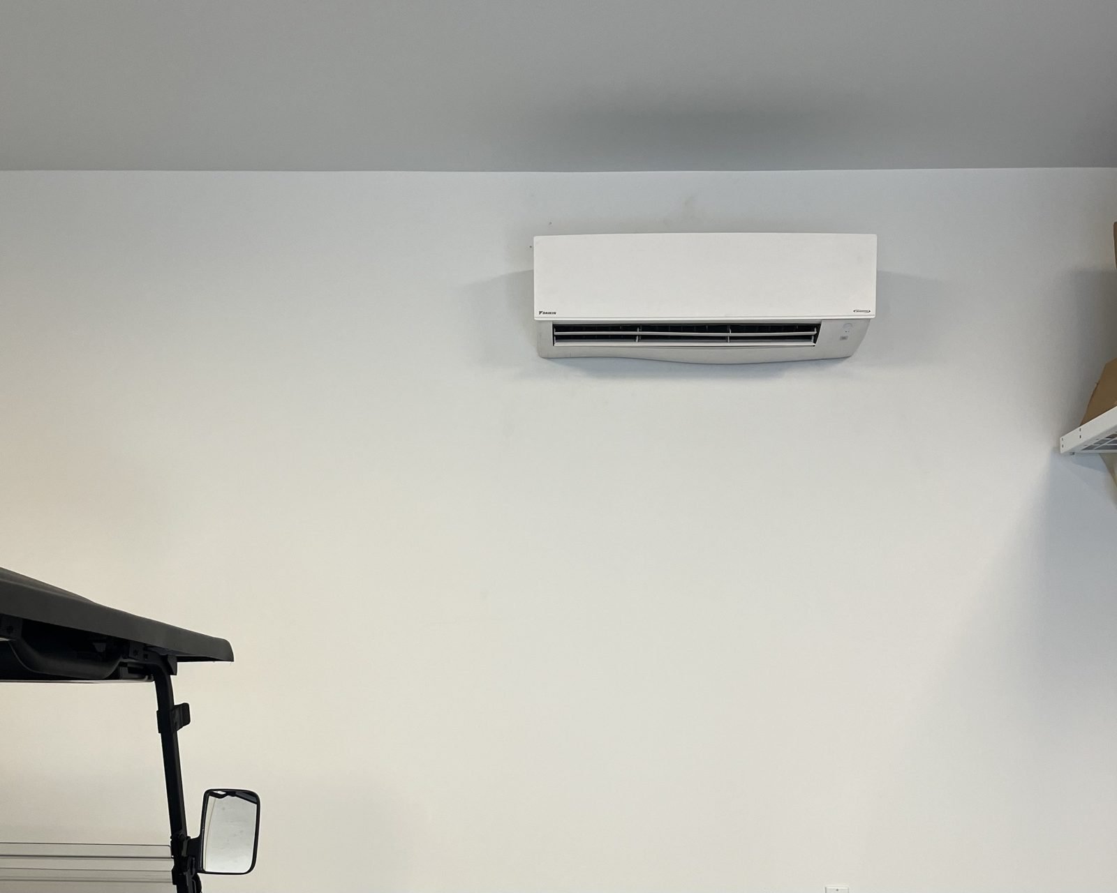 Daikin head in a garage. Golf cart stays cool, so does the person working on it.